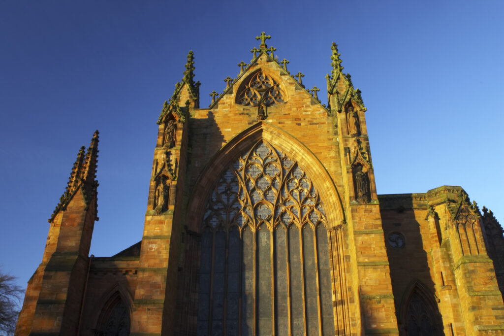 England, Cumbria, Carlisle Cathedral. Early morning winter sun illuminates the red sandstone of Carlisle Cathedral.
