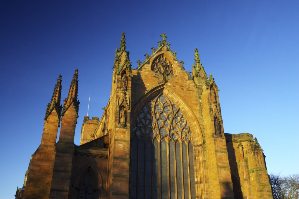 England, Cumbria, Carlisle Cathedral. Early morning winter sun illuminates the red sandstone of Carlisle Cathedral.