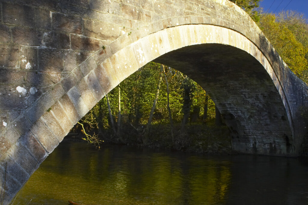 England, Cumbria, Cumbria Way Track. Bell Bridge, stretching over the River Caldrew.