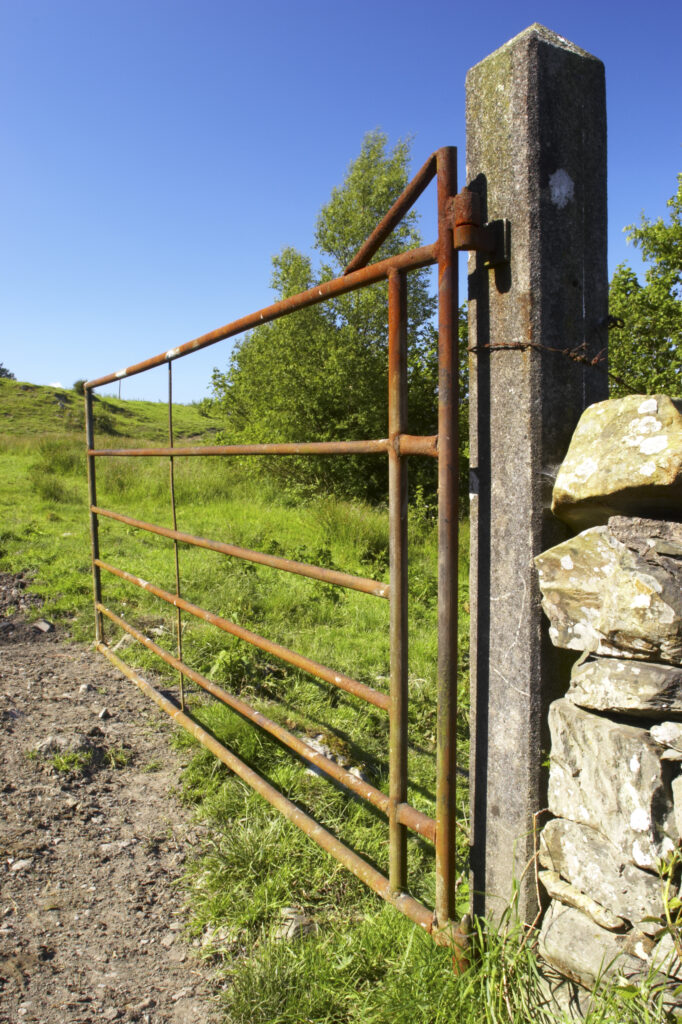 England, Cumbria, Lake District National Park. Rusty farm gate on the Cumbria Way track near to Kendall ground.