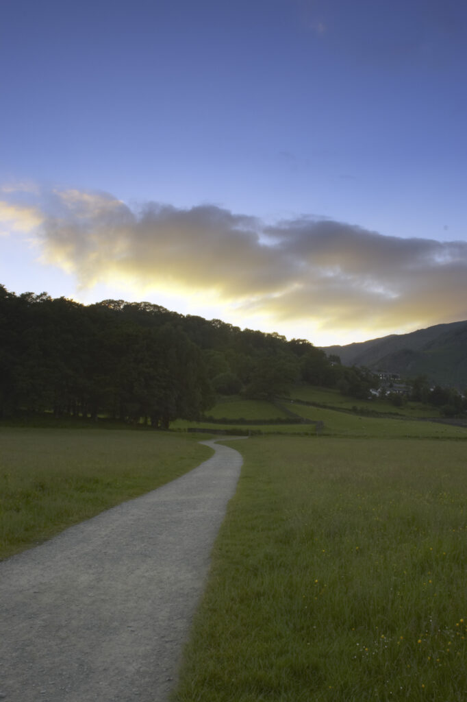 England, Cumbria, Lake District National Park. Evening light illuminates the Cumbria Way Track near Coniston.