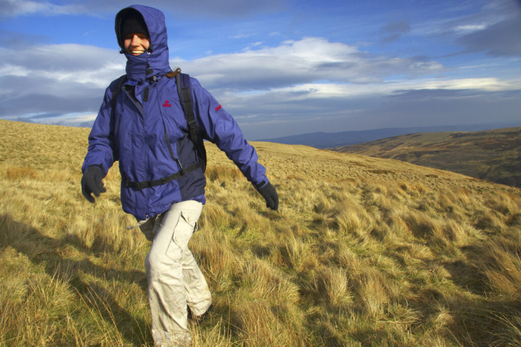 England, Northumberland, Northumberland National Park. Female hiker walking from Snear Hill in the Harthope Valley.