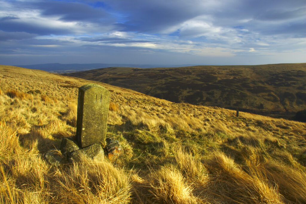 England, Northumberland, Northumberland National Park. Milestone on the banks of Snear Hill, high above the Harthope Valley.