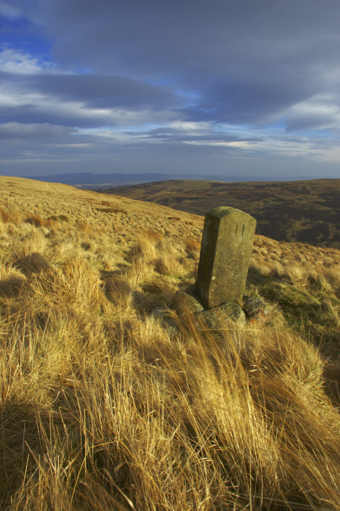 England, Northumberland, Northumberland National Park. Milestone on the banks of Snear Hill, high above the Harthope Valley.