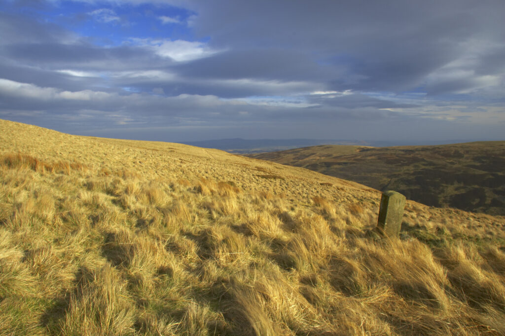 England, Northumberland, Northumberland National Park. Milestone on the banks of Snear Hill, high above the Harthope Valley.