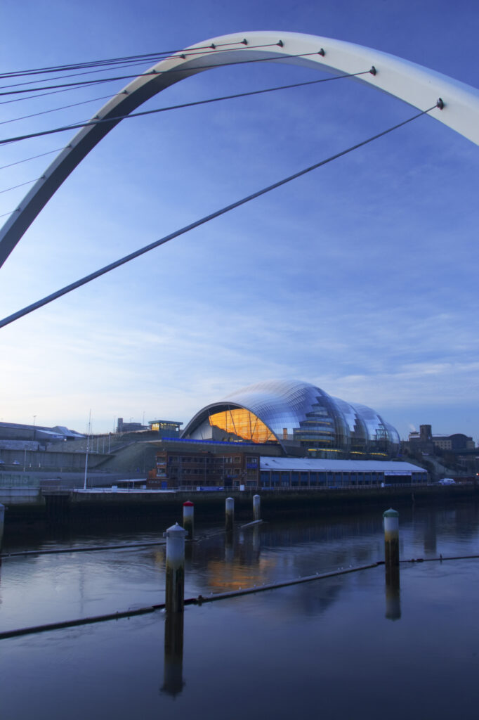 England, Tyne & Wear, Newcastle Upon Tyne. The Millennium Bridge and the Sage Gateshead building viewed from Newcastle quayside