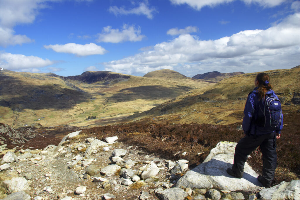 Wales, Caernarfonshire, Snowdonia National Park. Hiker admiring the landscape of the Ogwen Valley.