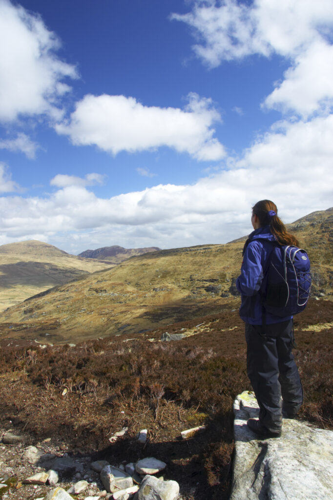 Wales, Caernarfonshire, Snowdonia National Park. Hiker admiring the landscape of the Ogwen Valley.