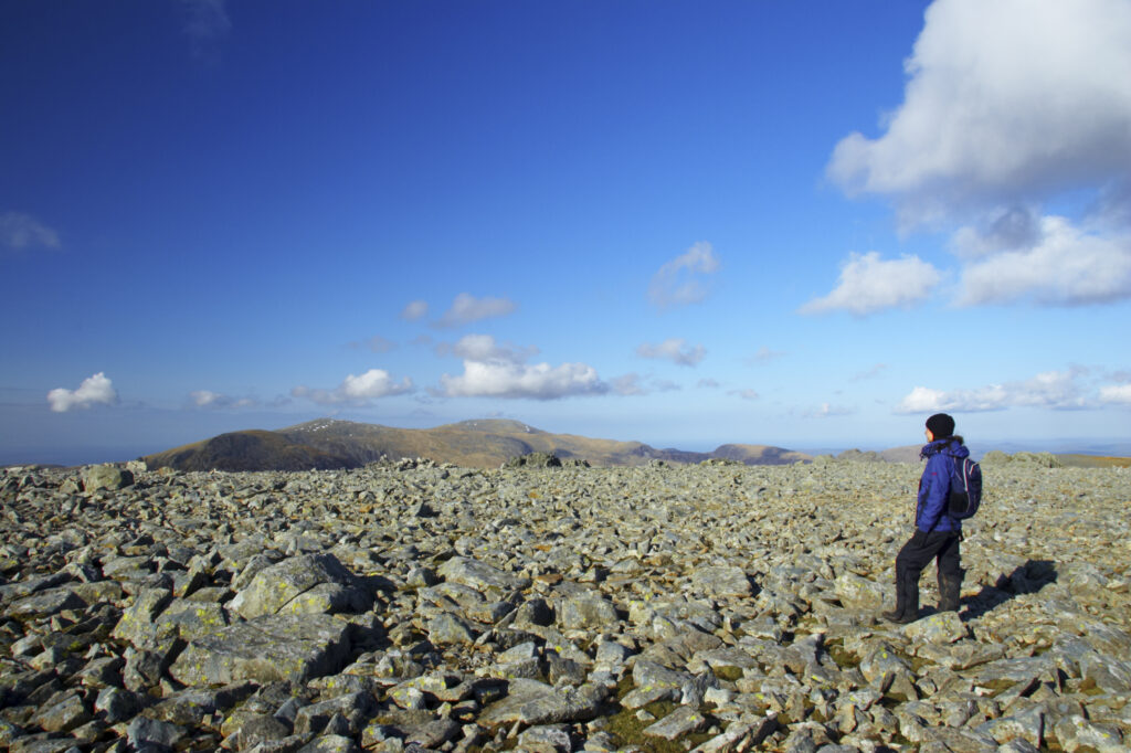 Wales, Caernarfonshire, Snowdonia National Park. Hiker on a plateau near the summit of Glyder Fawr.