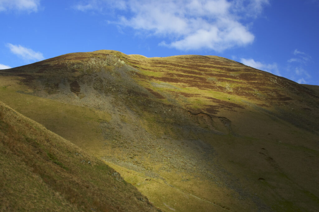 England, Cumbria, Yorkshire Dales National Park. A shaft of light illuminates the hills of the park, located to the north east of the town of Sedbergh. Viewed from the Howgills.