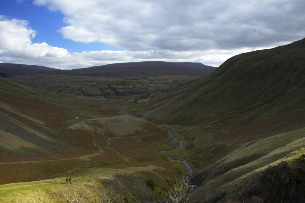 England, Cumbria, Yorkshire Dales National Park. A shaft of light illuminates the hills of the park, located to the north east of the town of Sedbergh. Viewed from the Howgills.