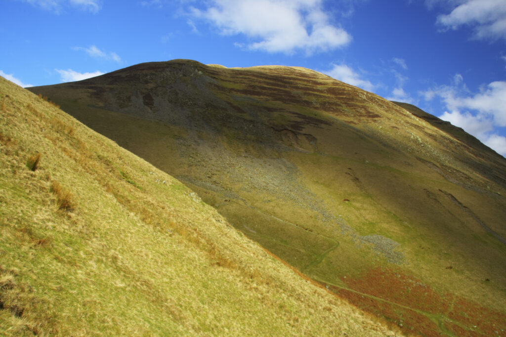 England, Cumbria, Yorkshire Dales National Park. A shaft of light illuminates the hills of the park, located to the north east of the town of Sedbergh. Viewed from the Howgills.