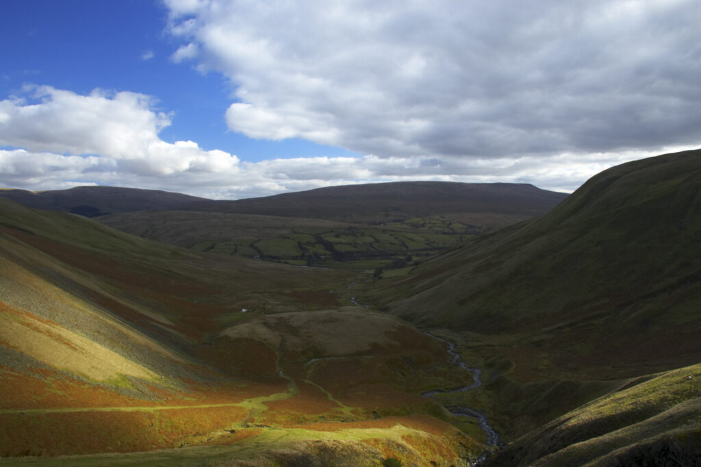 England, Cumbria, Yorkshire Dales National Park. A shaft of light illuminates the hills of the park, located to the north east of the town of Sedbergh. Viewed from the Howgills.