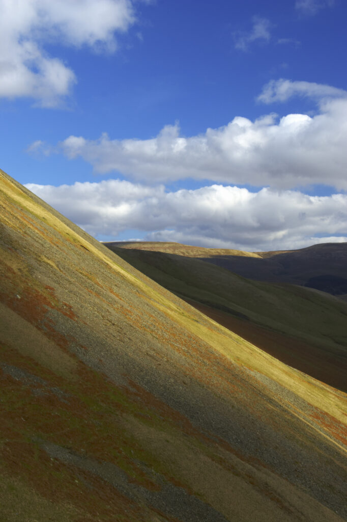England, Cumbria, Yorkshire Dales National Park. A shaft of light illuminates the hills of the park, located to the north east of the town of Sedbergh. Viewed from the Howgills.