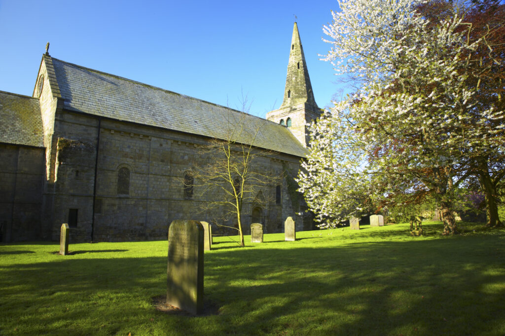England, Northumberland, Warkworth. The church of St.Lawrence and the colours of spring foliage, in Warkworth Village, located near the Northumberland Heritage Coast.