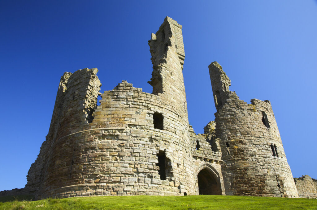 England, Northumberland, Dunstanburgh Castle. The ruins of the impressive Dunstanburgh Castle (National Trust / English Heritage) located along the Northumberland Heritage Coast near Craster.