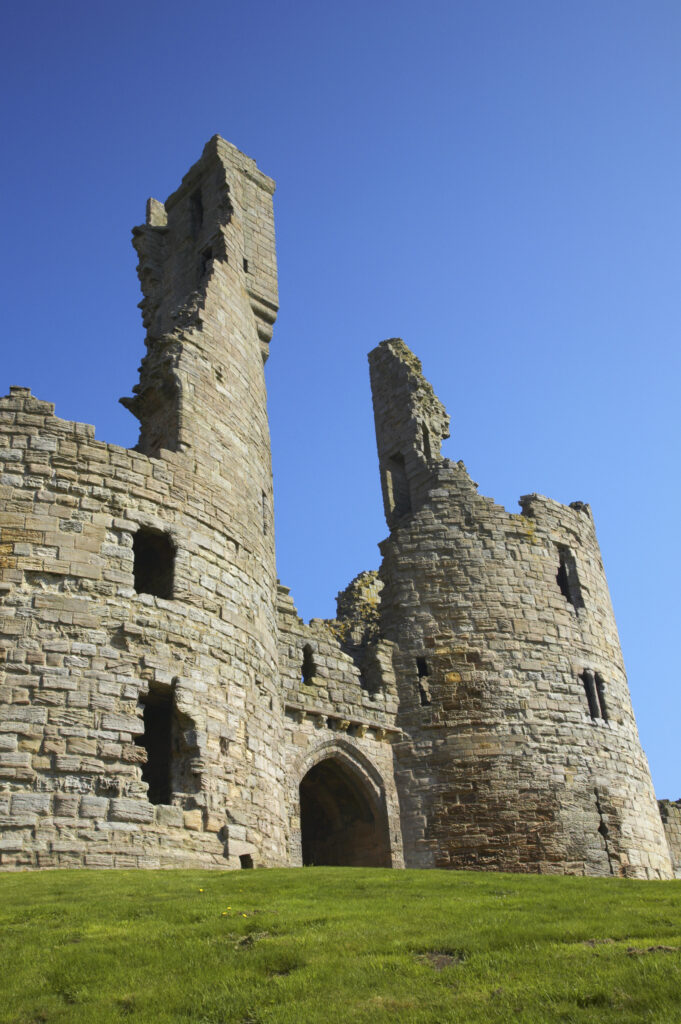 England, Northumberland, Dunstanburgh Castle. The ruins of the impressive Dunstanburgh Castle (National Trust / English Heritage) located along the Northumberland Heritage Coast near Craster.