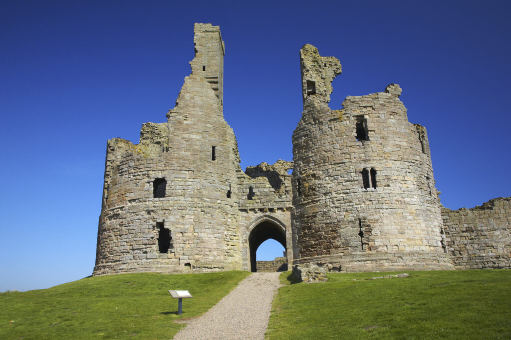 England, Northumberland, Dunstanburgh Castle. The ruins of the impressive Dunstanburgh Castle (National Trust / English Heritage) located along the Northumberland Heritage Coast near Craster.