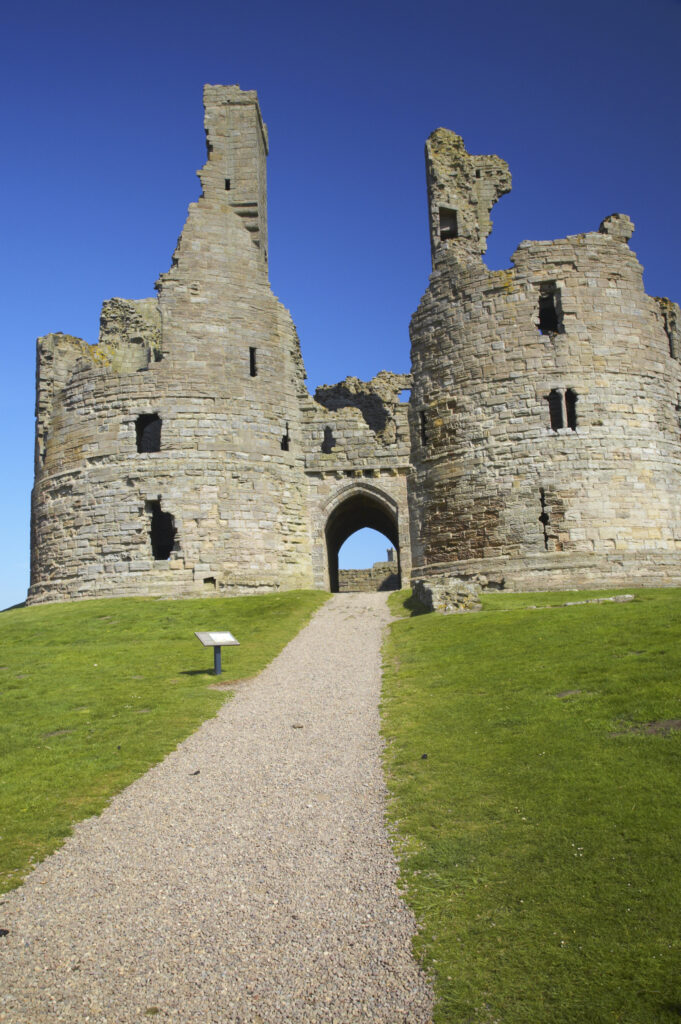 England, Northumberland, Dunstanburgh Castle. The ruins of the impressive Dunstanburgh Castle (National Trust / English Heritage) located along the Northumberland Heritage Coast near Craster.