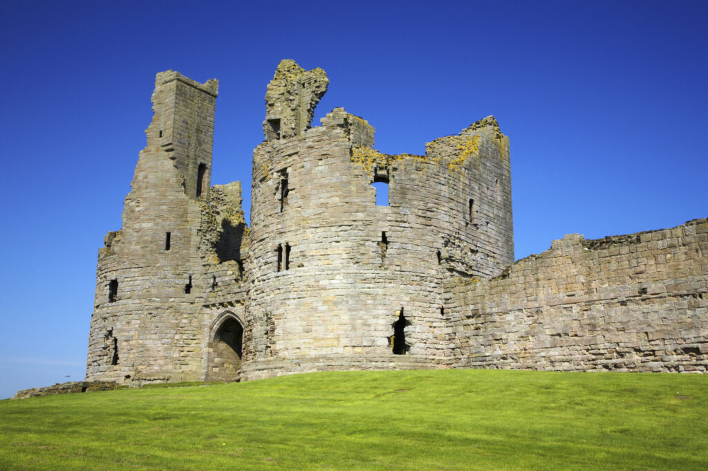 England, Northumberland, Dunstanburgh Castle. The ruins of the impressive Dunstanburgh Castle (National Trust / English Heritage) located along the Northumberland Heritage Coast near Craster.