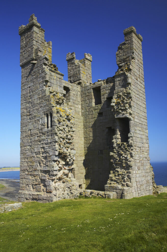 England, Northumberland, Dunstanburgh Castle. The ruins of the impressive Dunstanburgh Castle (National Trust / English Heritage) located along the Northumberland Heritage Coast near Craster.