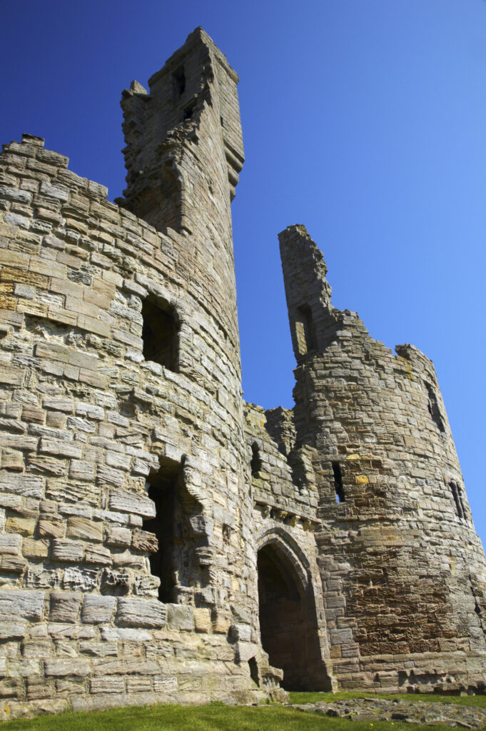 England, Northumberland, Dunstanburgh Castle. The ruins of the impressive Dunstanburgh Castle (National Trust / English Heritage) located along the Northumberland Heritage Coast near Craster.