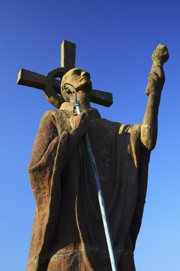 England, Northumberland, Lindisfarne / Holy Island. Statue of St. Aidan in the grounds of the Lindisfarne Priory, located upon Holy Island along the Northumberland Heritage Coast.