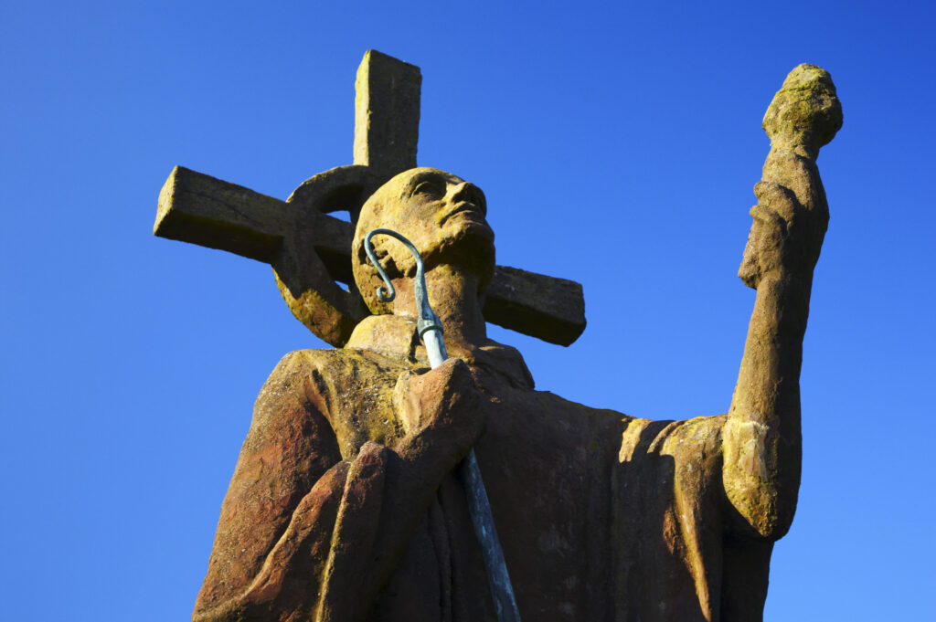 England, Northumberland, Lindisfarne / Holy Island. Statue of St. Aidan in the grounds of the Lindisfarne Priory, located upon Holy Island along the Northumberland Heritage Coast.