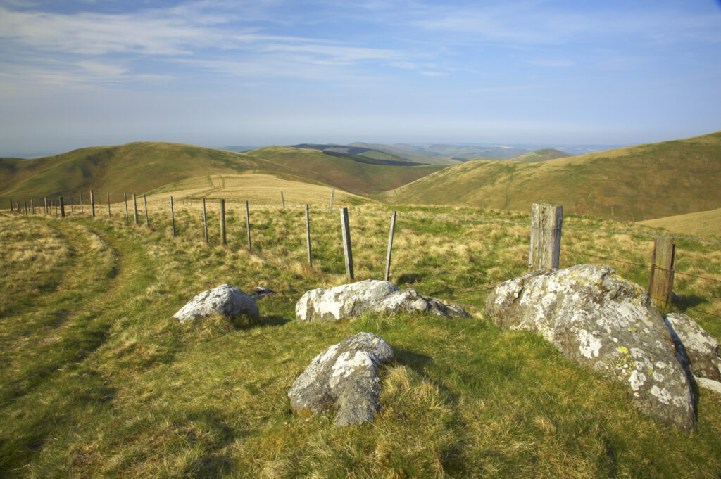 Scotland, Scottish Borders, The Pennine Way. The route of the Pennine Way high level route near Kirk Yetholm, following the double wire fence indicating the English / Scottish border.