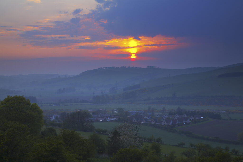 Scotland, Scottish Borders, The Pennine Way. Sunset behind the Scottish Upland Hill near Kirk Yetholm, on the final stretch of the Pennine Way.