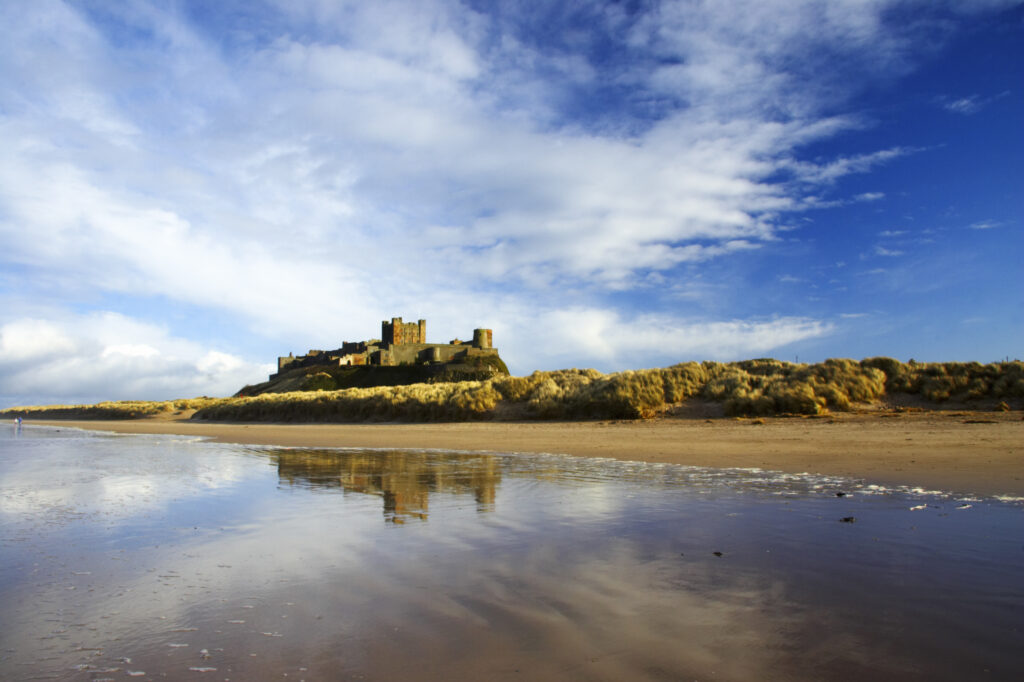 England, Northumberland, Bamburgh Castle. Bamburgh Castle and dunes near Bamburgh village.