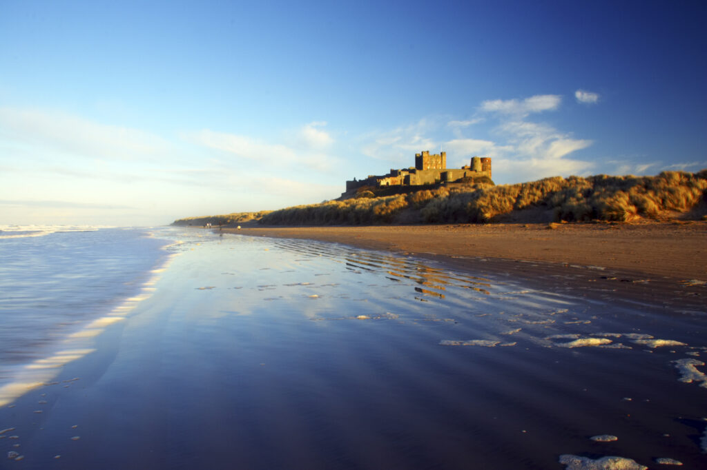 England, Northumberland, Bamburgh Castle. Bamburgh Castle and dunes near Bamburgh village.
