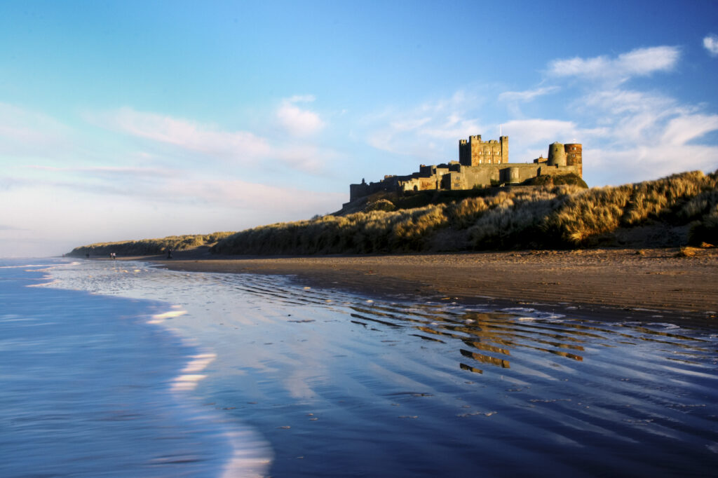 England, Northumberland, Bamburgh Castle. Bamburgh Castle and dunes near Bamburgh village.