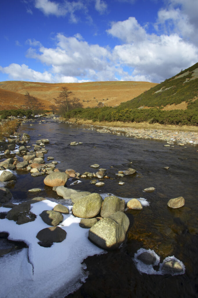 England, Northumberland, Northumberland National Park. A winter scene with the remains of snow on the river Breamish, running through the Cheviots and the Breamish valley near the village of Ingram situated within the Northumberland National Park in the northen england county of Northumberland about 8km east of the border with Scotland.