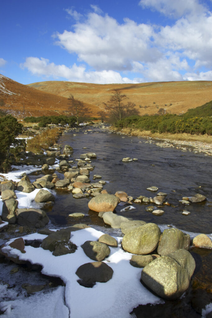 England, Northumberland, Northumberland National Park. A winter scene with the remains of snow on the river Breamish, running through the Cheviots and the Breamish valley near the village of Ingram situated within the Northumberland National Park in the northen england county of Northumberland about 8km east of the border with Scotland.