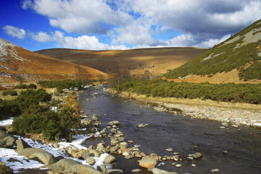 England, Northumberland, Northumberland National Park. A winter scene with the remains of snow on the river Breamish, running through the Cheviots and the Breamish valley near the village of Ingram situated within the Northumberland National Park in the northen england county of Northumberland about 8km east of the border with Scotland.