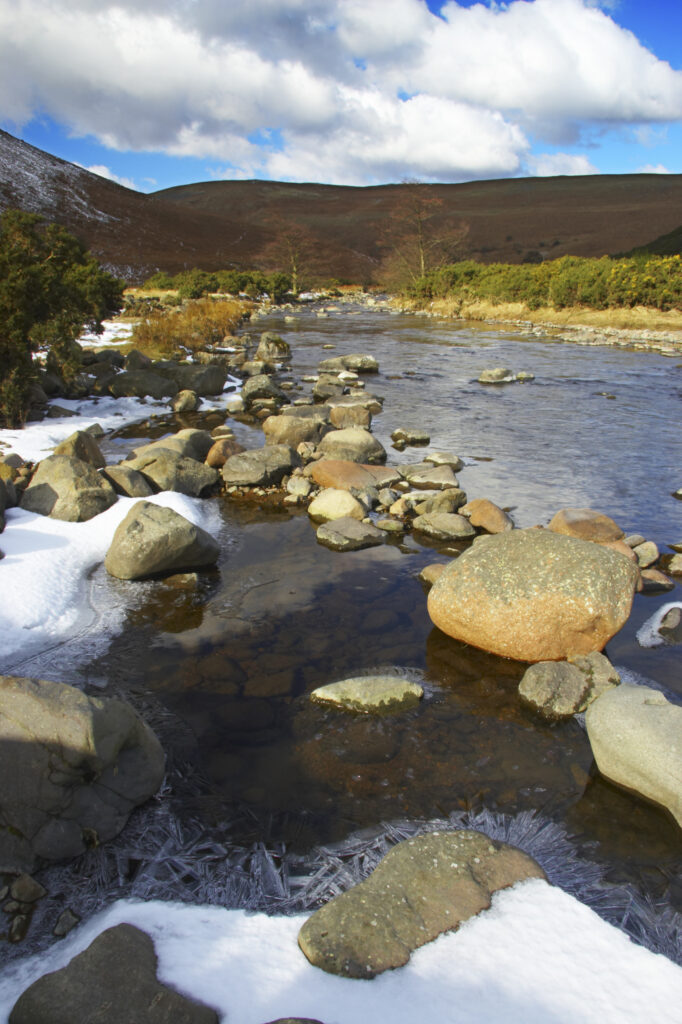 England, Northumberland, Northumberland National Park. A winter scene with the remains of snow on the river Breamish, running through the Cheviots and the Breamish valley near the village of Ingram situated within the Northumberland National Park in the northen england county of Northumberland about 8km east of the border with Scotland.