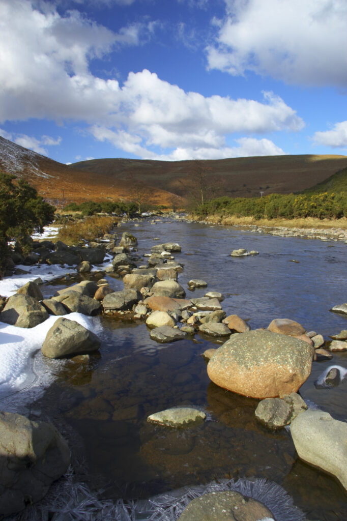 England, Northumberland, Northumberland National Park. A winter scene with the remains of snow on the river Breamish, running through the Cheviots and the Breamish valley near the village of Ingram situated within the Northumberland National Park in the northen england county of Northumberland about 8km east of the border with Scotland.