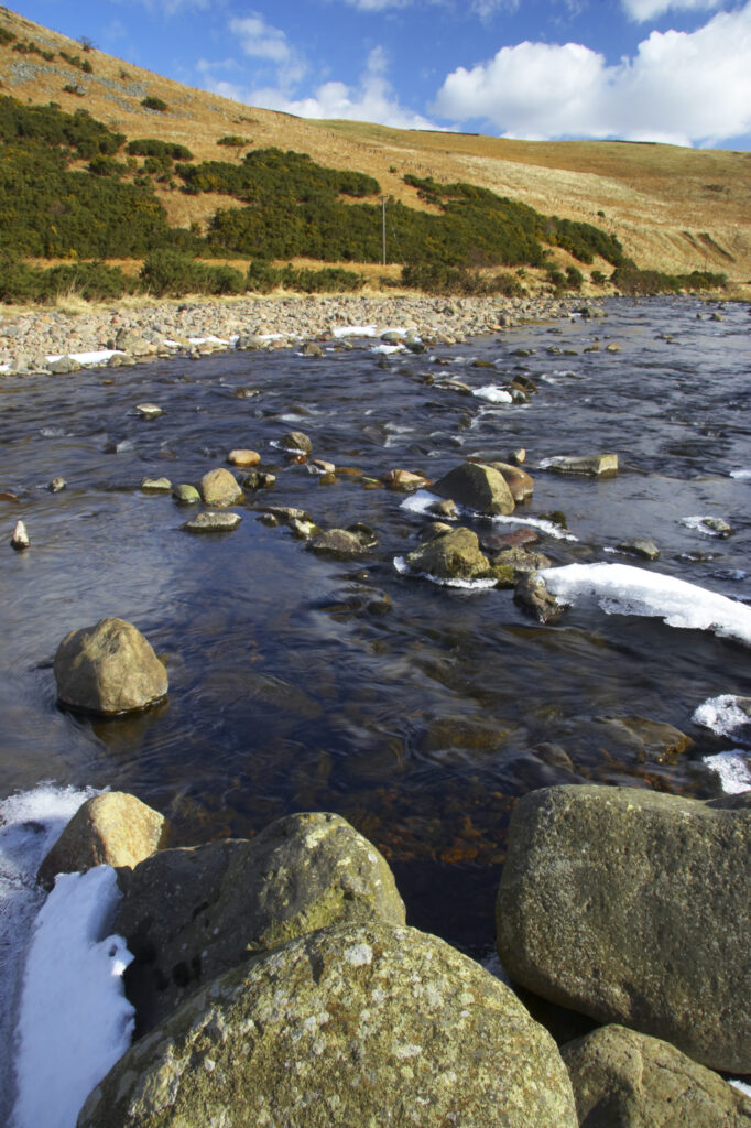 England, Northumberland, Northumberland National Park. A winter scene with the remains of snow on the river Breamish, running through the Cheviots and the Breamish valley near the village of Ingram situated within the Northumberland National Park in the northen england county of Northumberland about 8km east of the border with Scotland.