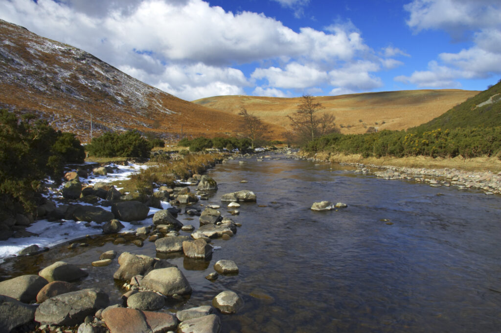 England, Northumberland, Northumberland National Park. A winter scene with the remains of snow on the river Breamish, running through the Cheviots and the Breamish valley near the village of Ingram situated within the Northumberland National Park in the northen england county of Northumberland about 8km east of the border with Scotland.