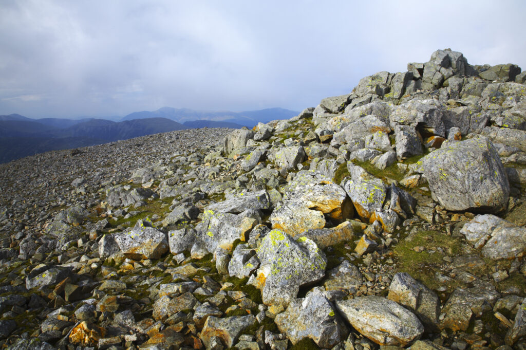 England, Cumbria, Lake District National Park. Cairn on the rocky summit of Great Gable in the Western Lakes