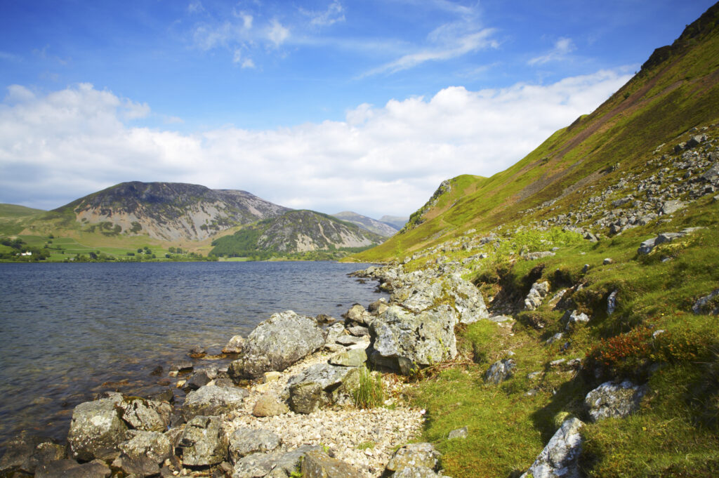 England, Cumbria, Lake District National Park The rocky lake shore of Ennerdale Water in the western region of the Lake District