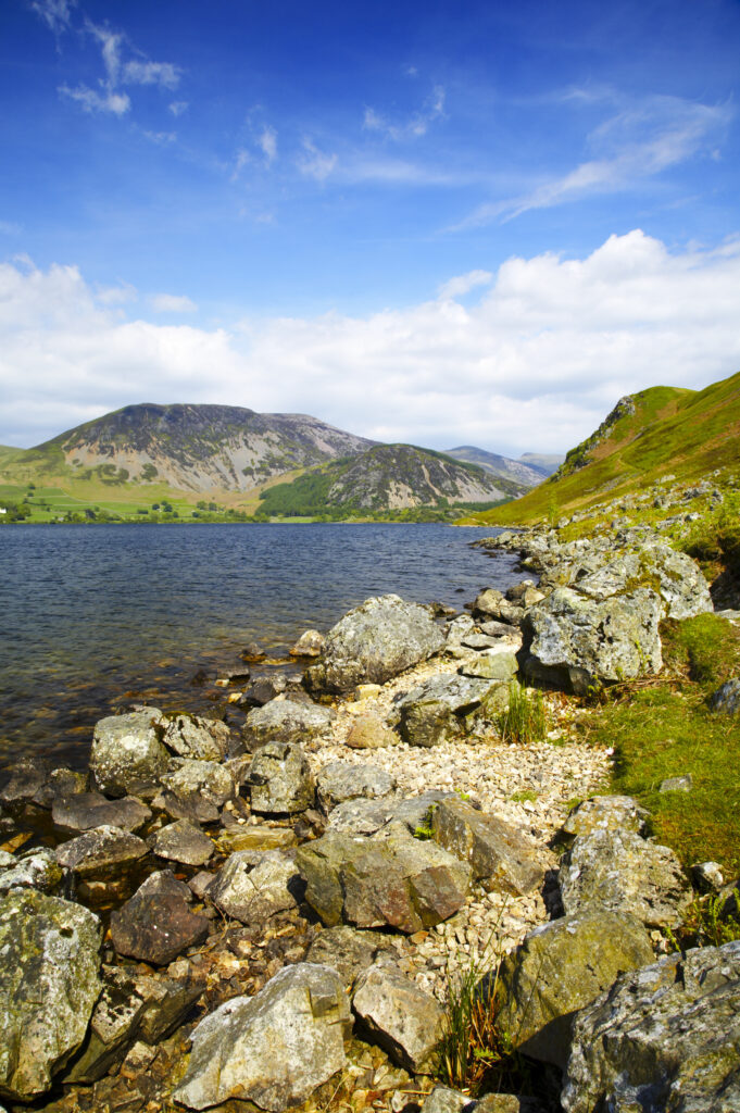 England, Cumbria, Lake District National Park The rocky lake shore of Ennerdale Water in the western region of the Lake District