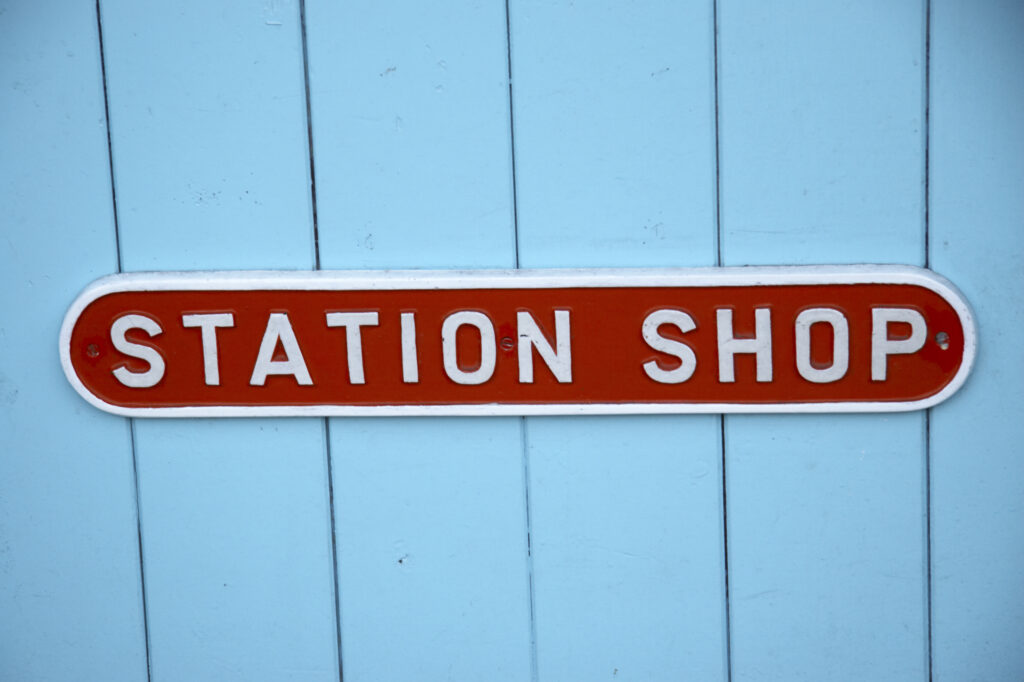England, North Yorkshire, North York Moors National Park. Station shop sign within the grounds of Grosmont Station.