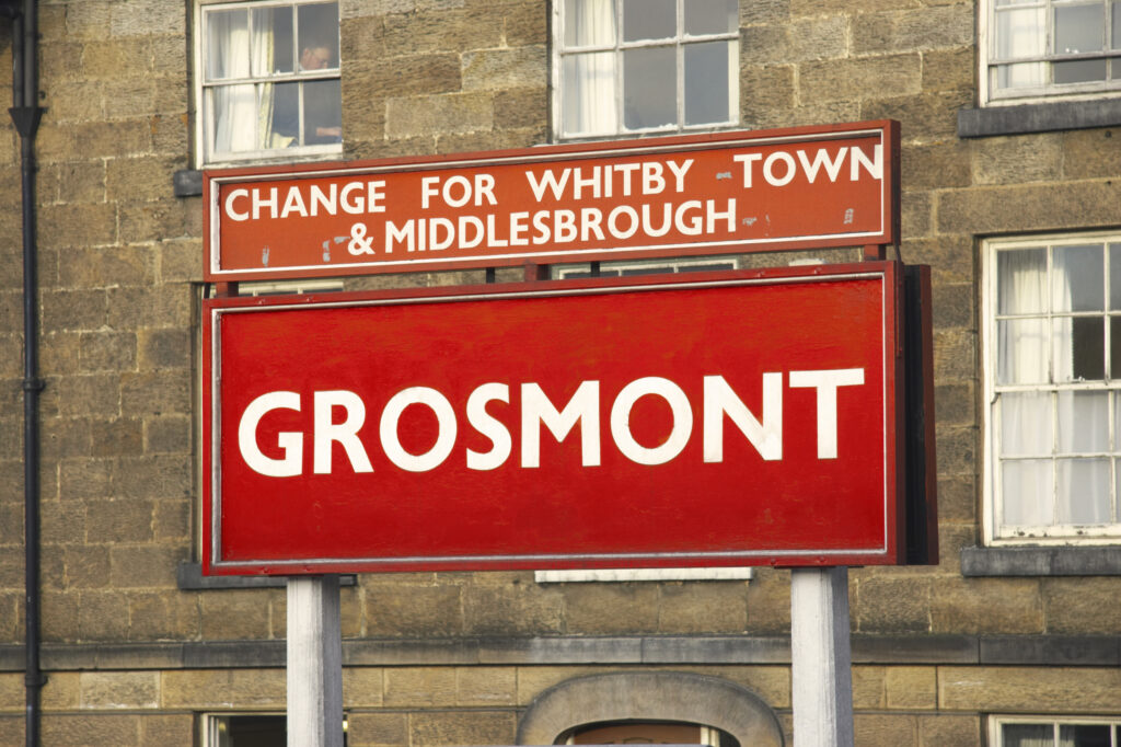 England, North Yorkshire, North York Moors National Park. Grosmont sign within the grounds of Grosmont Station.