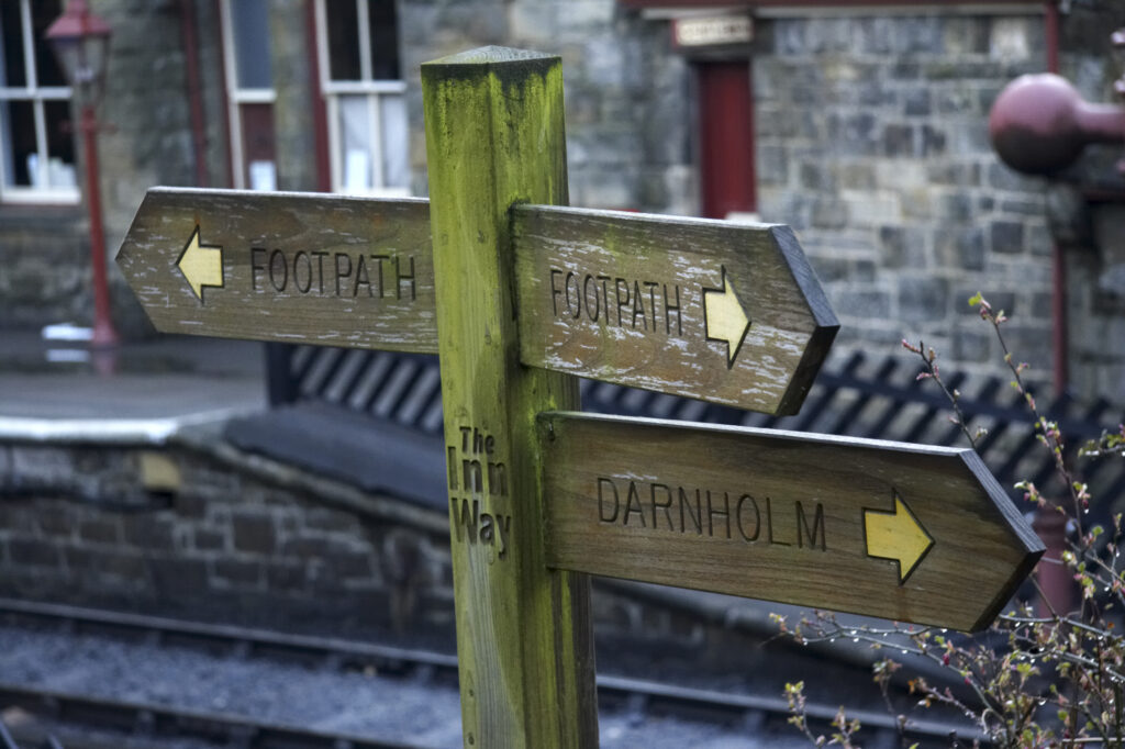 England, North Yorkshire, North York Moors National Park. The Inn Way sign post near Goathland station.
