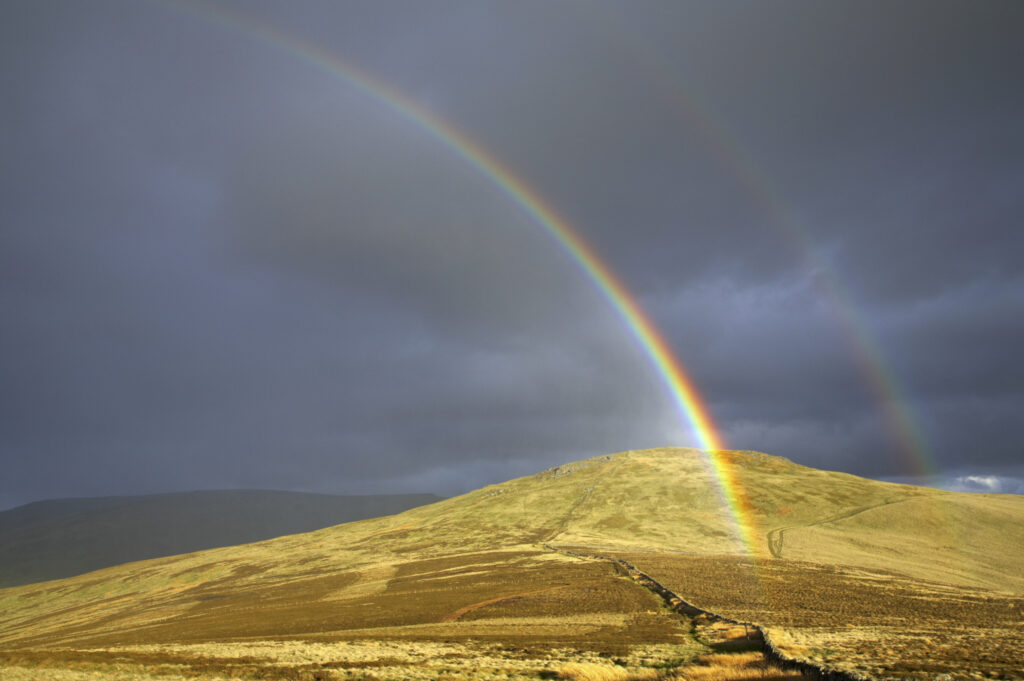 England, Northumberland, The Pennine Way. A rainbow above the Schil on the England / Scottish Border.