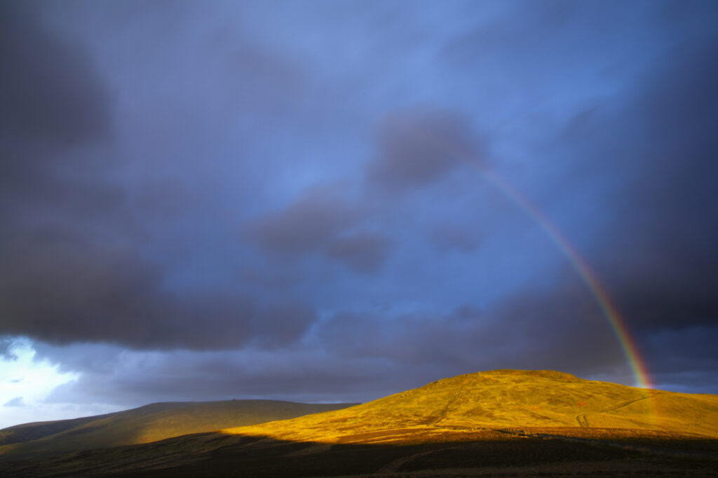 England, Northumberland, The Pennine Way. A rainbow above the Schil on the England / Scottish Border.