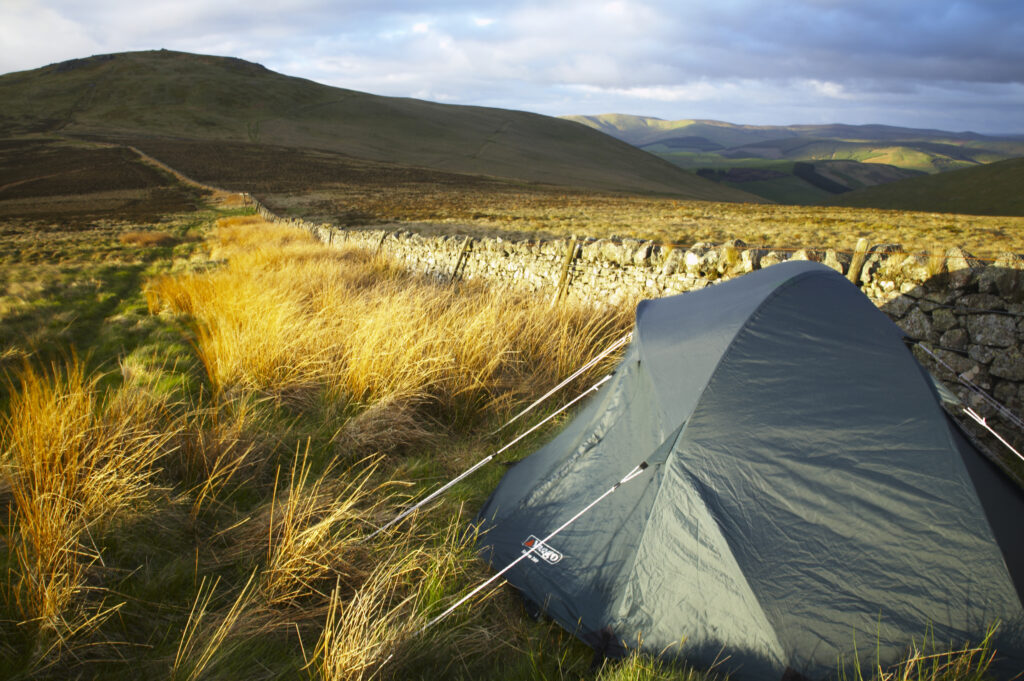 England Northumberland The Pennine Way Wild camp site near to the wall marking the England Scotland border with the Schil in the distance.