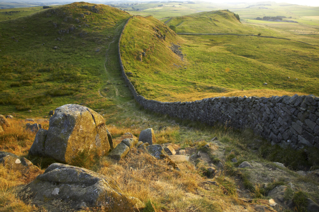 ENGLAND Northumberland Hadrians Wall Sunset behind the world heritage site of Hadrians Wall near the town of Once Brewed.